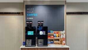 Two coffee machines on a counter with a sign above them that reads 'MUST. HAVE. COFFEE.' - Holiday Inn Express Hotel & Suites Goshen by IHG (Goshen)