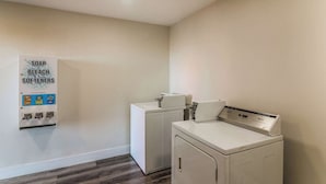 A laundry room with a sign listing soap, bleach, and softeners.