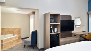 A modern hotel room with a large bed, a desk with a chair, a flat-screen TV, a microwave, a coffee maker, and a small refrigerator. - Holiday Inn Express Lewisburg/New Columbia by IHG (New Columbia)