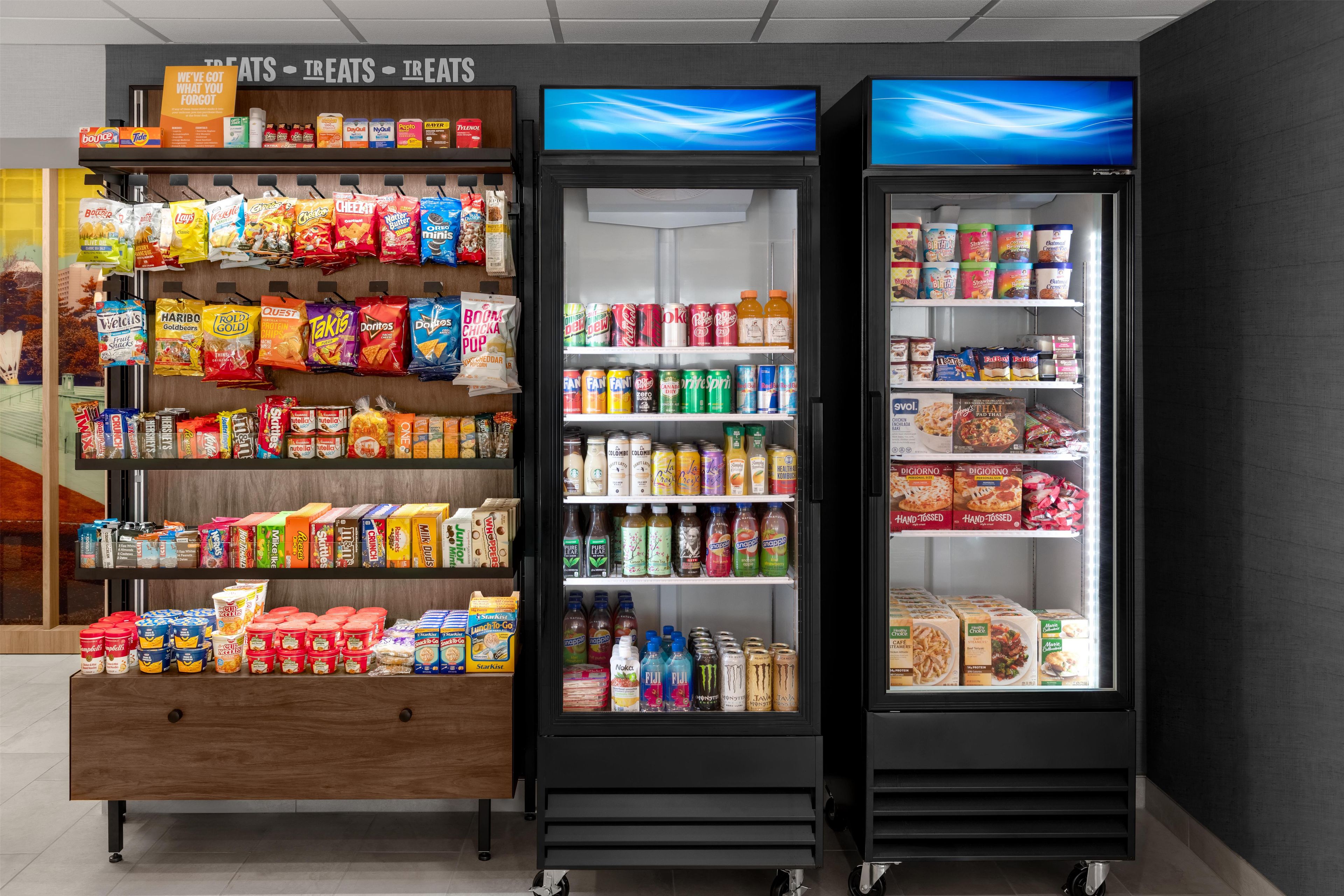 A refrigerated display case with snacks, beverages, and dairy products.