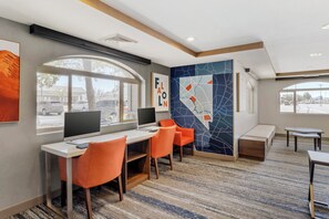A modern hotel room with a desk, two orange chairs, a large window, and a wall with abstract art. - Holiday Inn Express Fallon by IHG (Fallon)