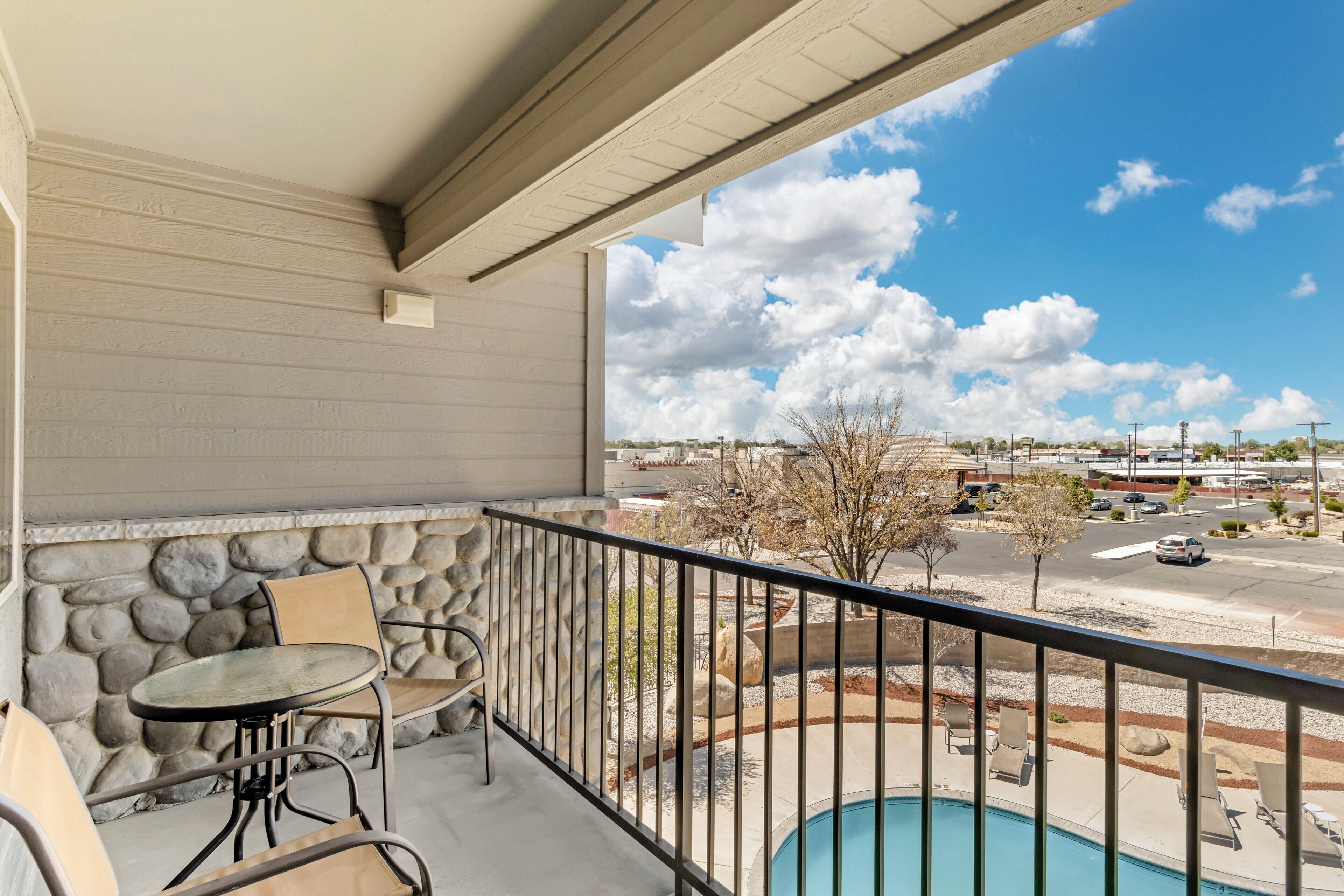 suite, 2 queen beds, balcony | in-room safe, desk, blackout curtains, iron/ironing board