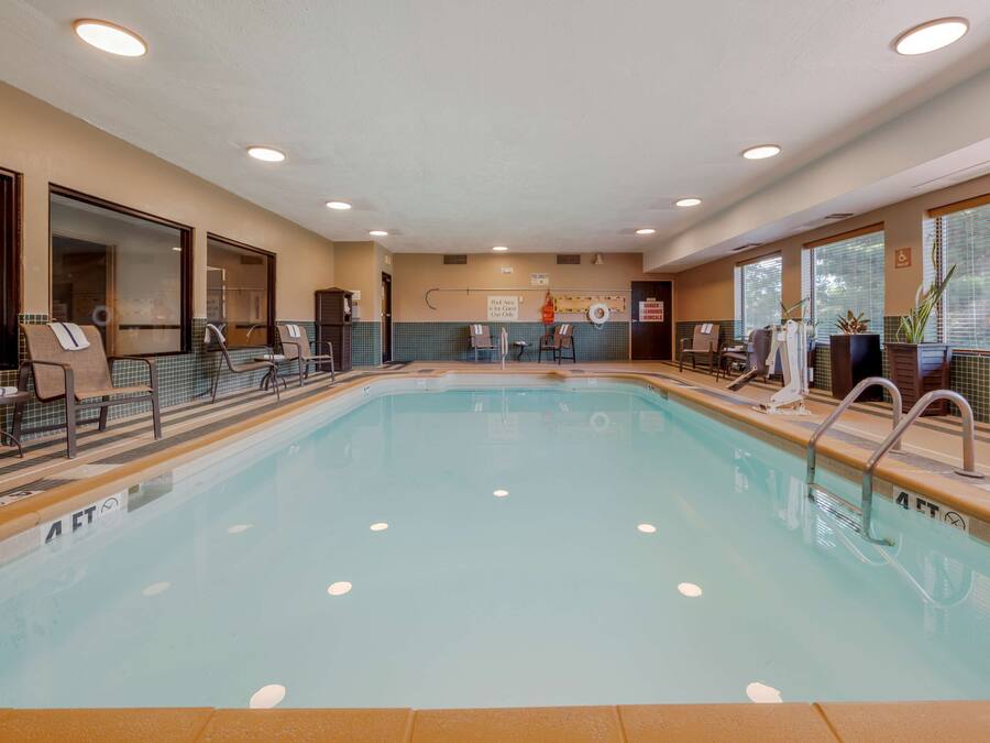 A swimming pool with lounge chairs and a changing room.