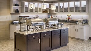 A modern kitchen with a central island, built-in cabinets, and pendant lighting. - Homewood Suites by Hilton Mobile Airport-University Area (Mobile)