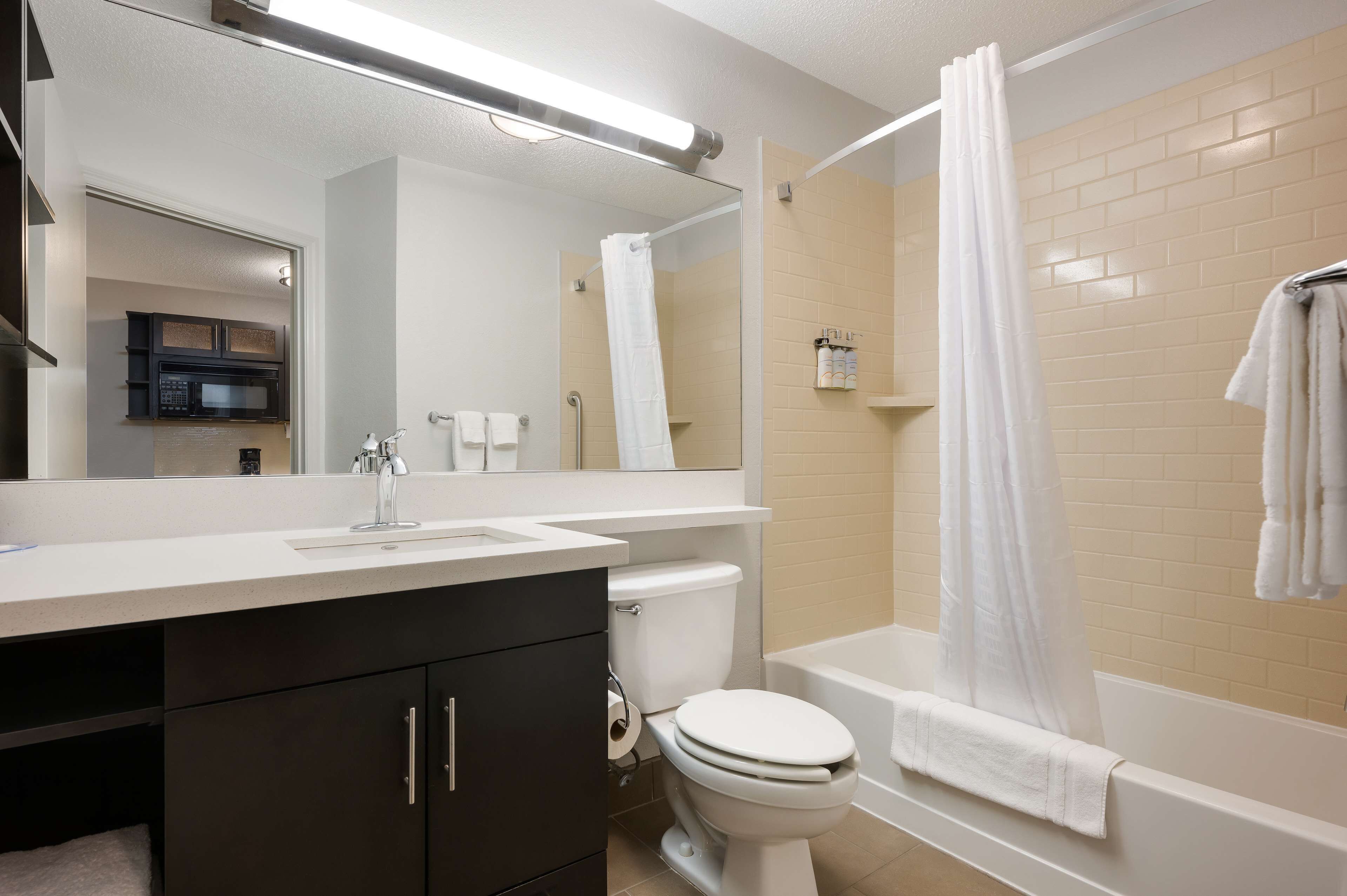 studio suite, 1 queen bed (studio) | bathroom | combined shower/bathtub, hair dryer, towels, soap