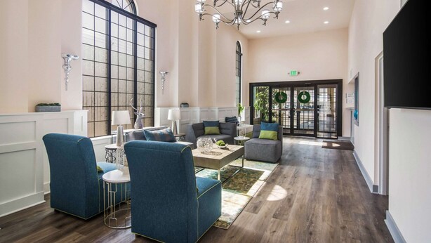 A spacious lobby with a chandelier, seating area, and a reception desk. - Quality Inn & Suites Lake City (Lake City)