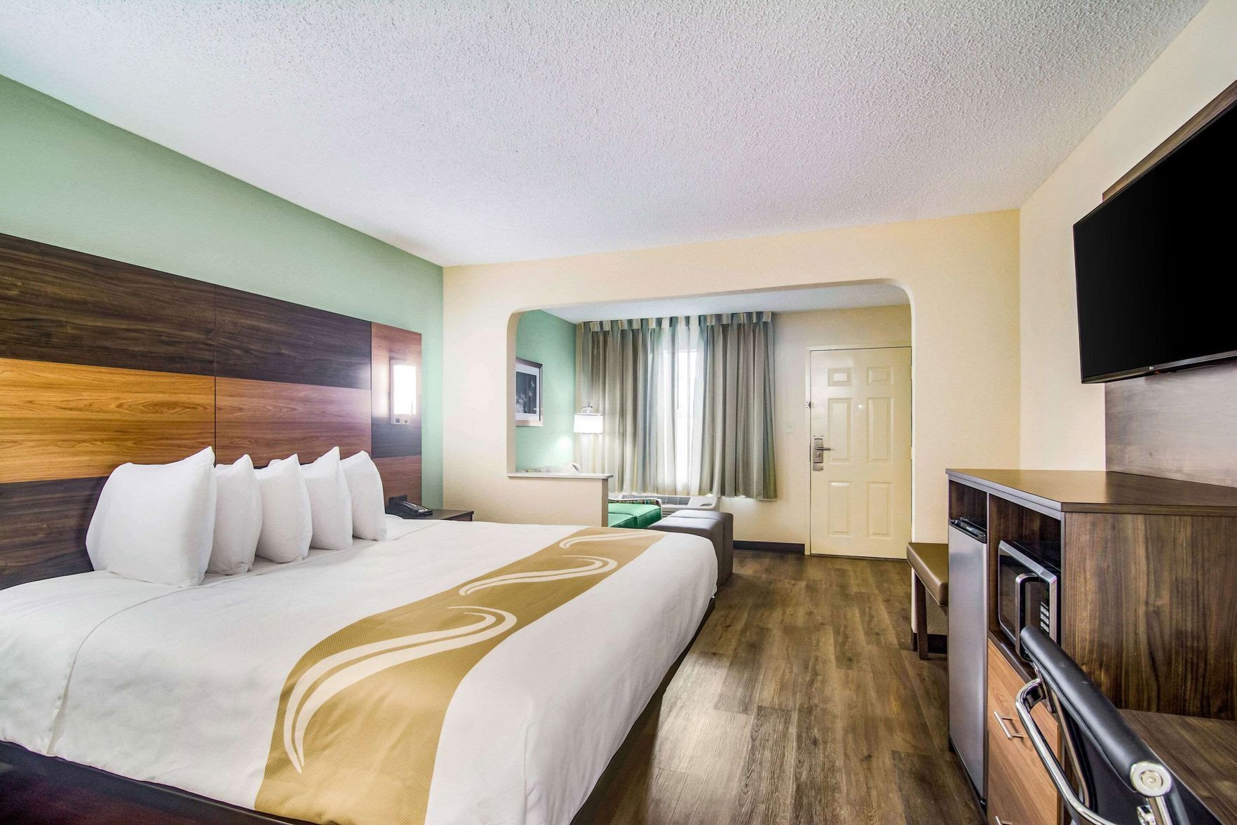 Premium bedding, desk, laptop workspace, blackout drapes