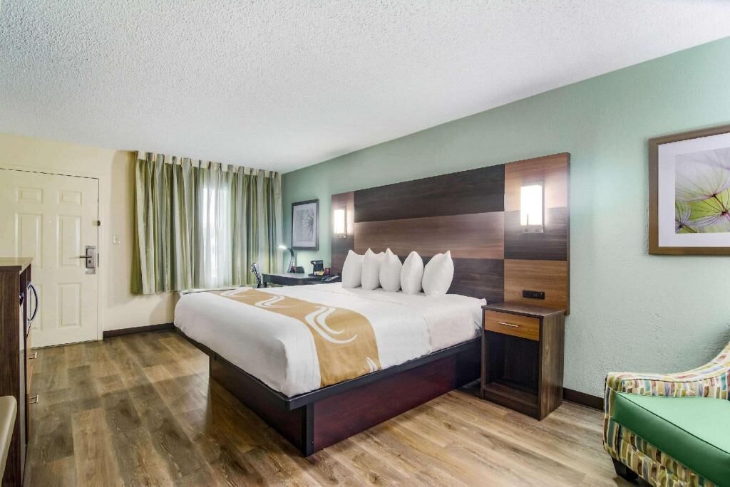 Premium bedding, desk, laptop workspace, blackout drapes