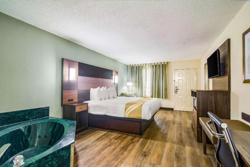 Premium bedding, desk, laptop workspace, blackout drapes