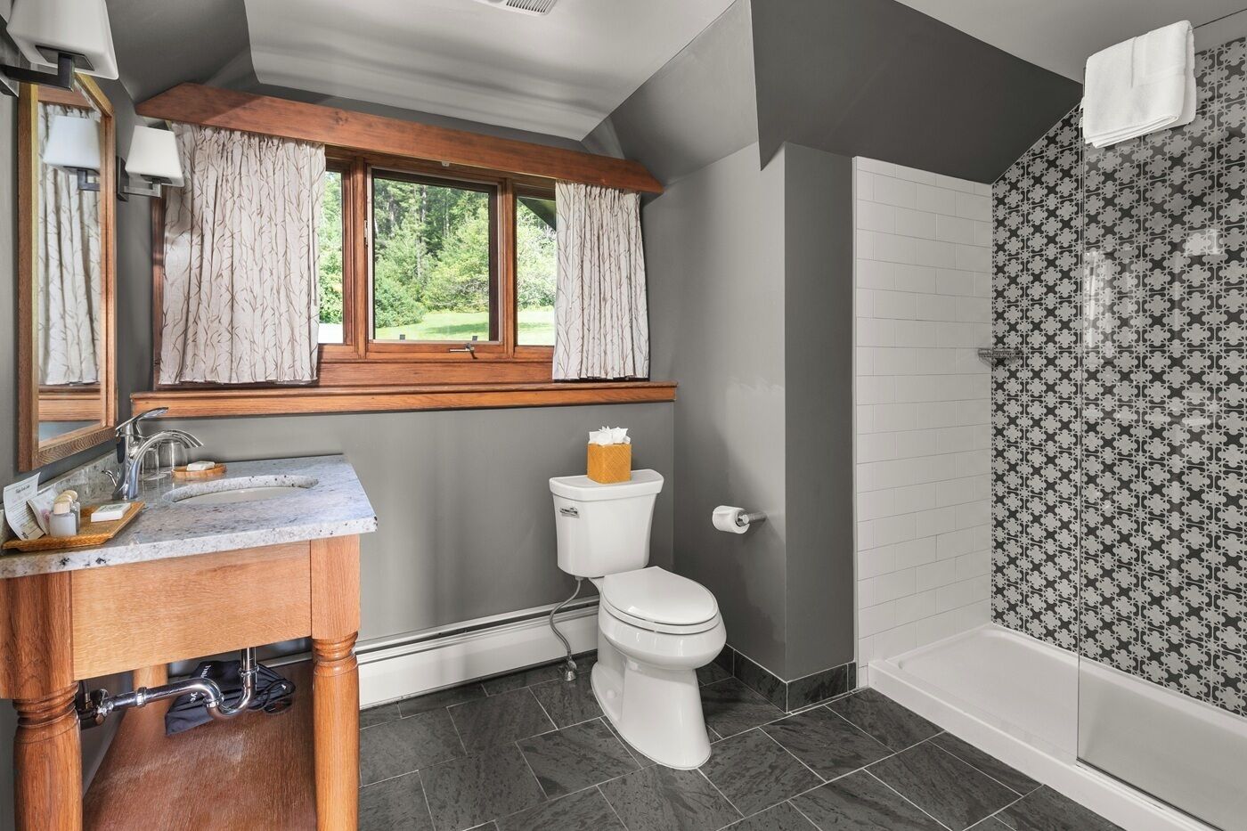 A bathroom with a toilet, sink, and shower.