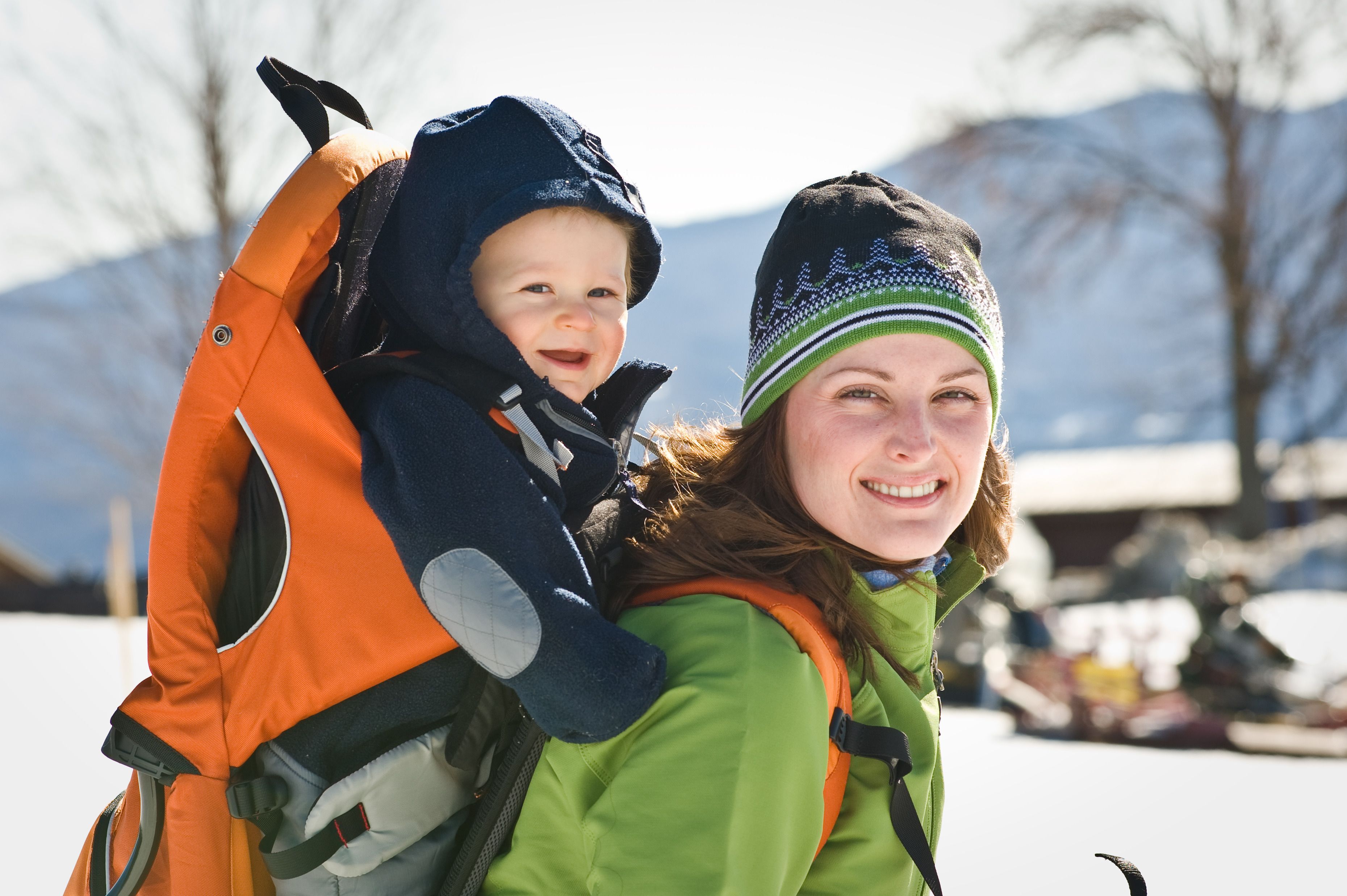 A person carrying a child in a backpack.