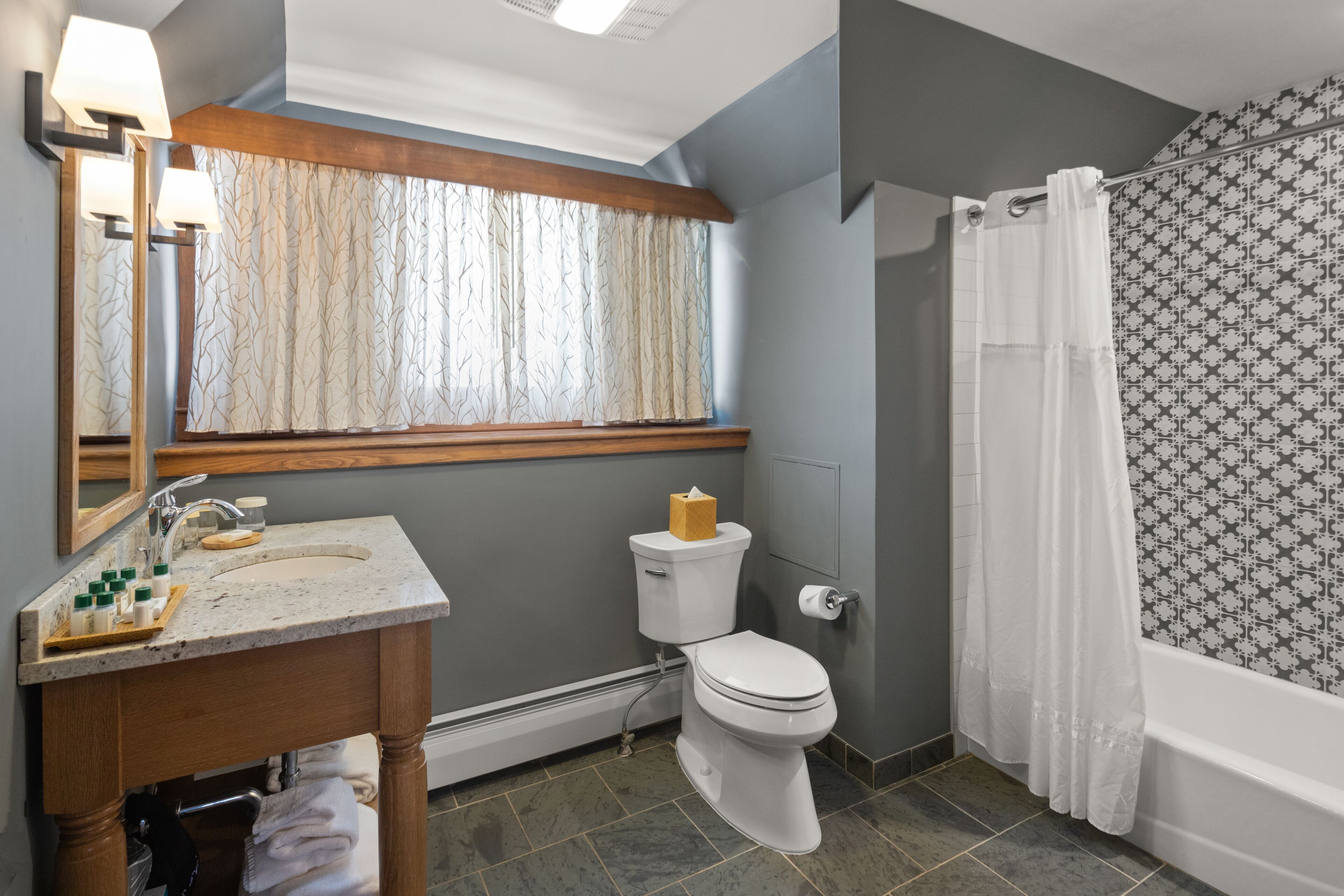 A bathroom with a sink, toilet, and bathtub.