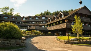 A large, multi-story lodge with a stone facade and multiple balconies.