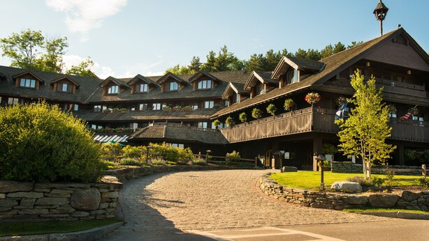 A large, multi-story lodge with a stone facade and multiple balconies. - von Trapp Family Lodge & Resort (Stowe)