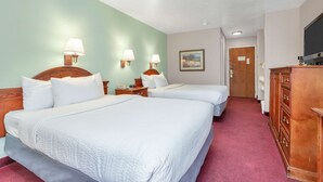 A hotel room with two beds, a wooden dresser, a television, and a painting on the wall. - Americas Best Value Inn Cedar City (Cedar City)