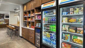 A food court with vending machines, seating, and a variety of food and drink options. - Courtyard by Marriott Kokomo (Kokomo)