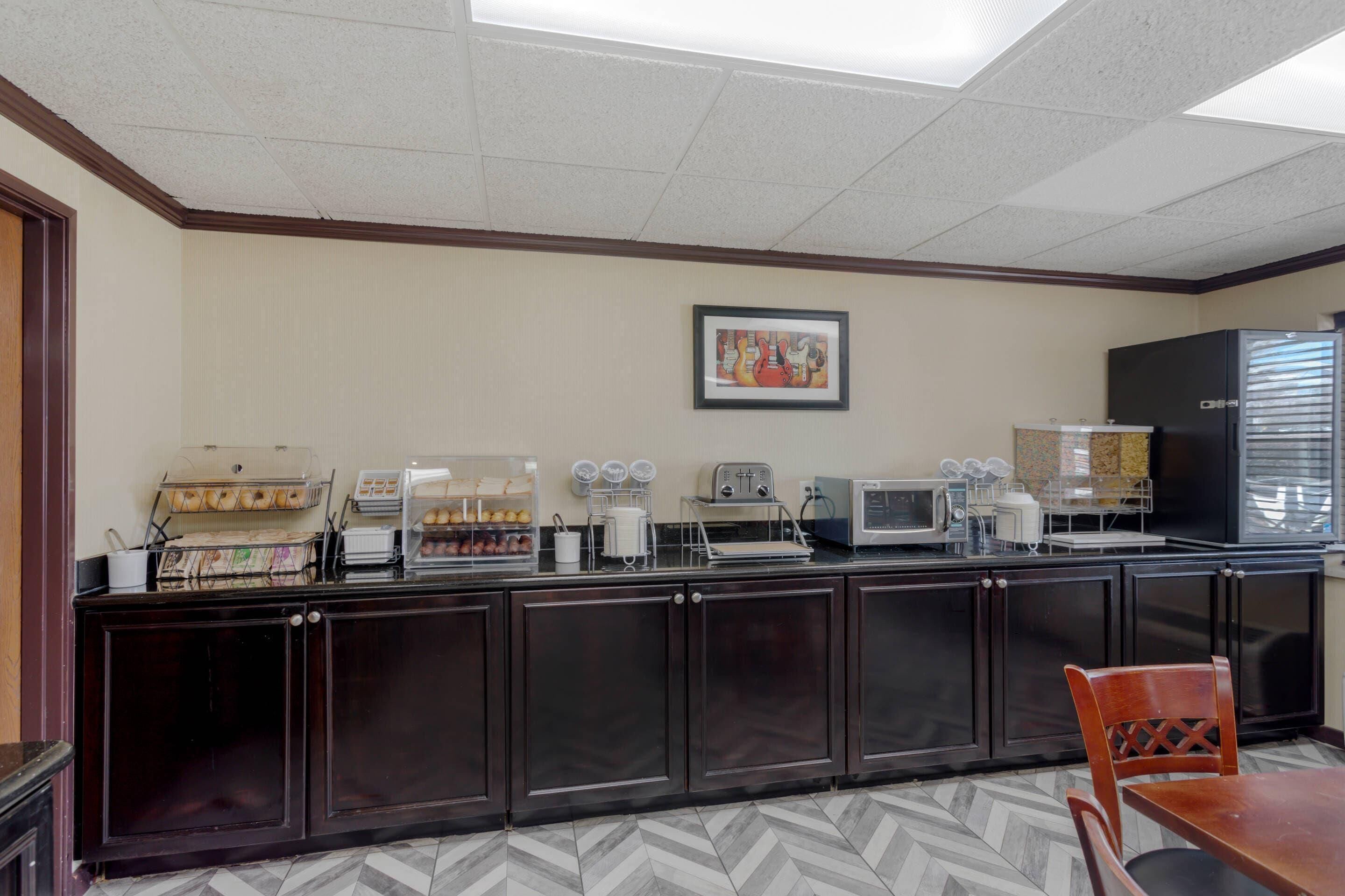 A kitchenette with a microwave, toaster, and coffee maker.
