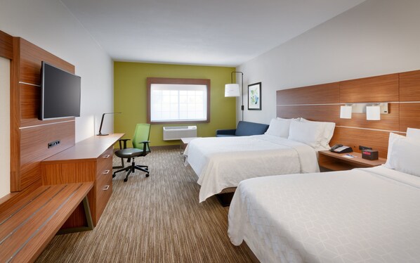 A hotel room with two beds, a desk with a flat-screen TV, a green chair, and a window with blinds. - Holiday Inn Express Heber City by IHG (Heber City)