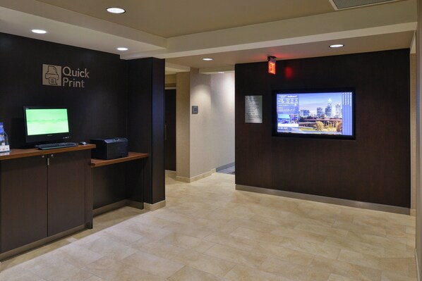 A reception area with a monitor, printer, and a sign for 'Quick Print'. - Courtyard by Marriott Charlotte/Matthews (Matthews)