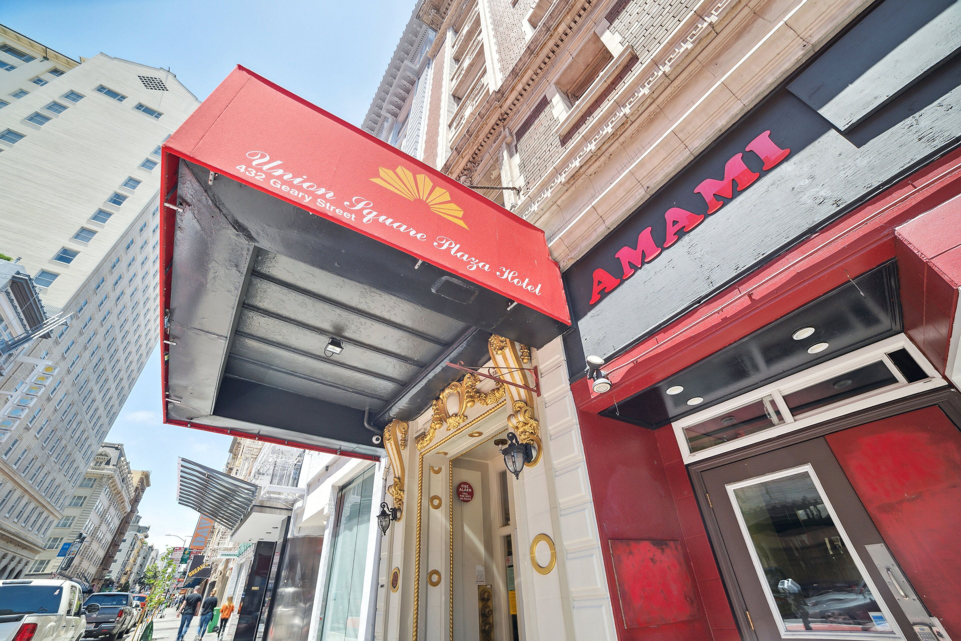 The exterior of the Union Square Plaza Hotel with a prominent AMAMI sign.