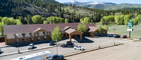 A motel with a parking lot, RV parking, and a sign for Quality Inn & Suites.