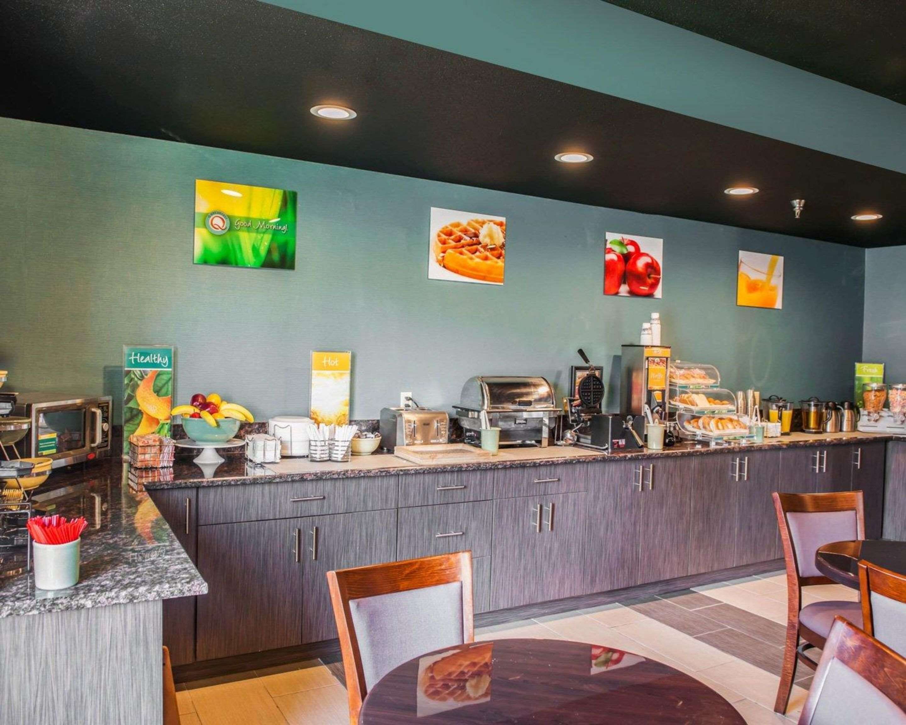 A breakfast bar with a variety of food items and a coffee machine.