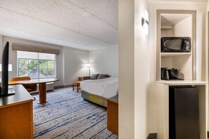 A hotel room with a bed, a desk, a chair, a window, and a microwave on a shelf. - La Quinta Inn & Suites by Wyndham Albuquerque West (Albuquerque)