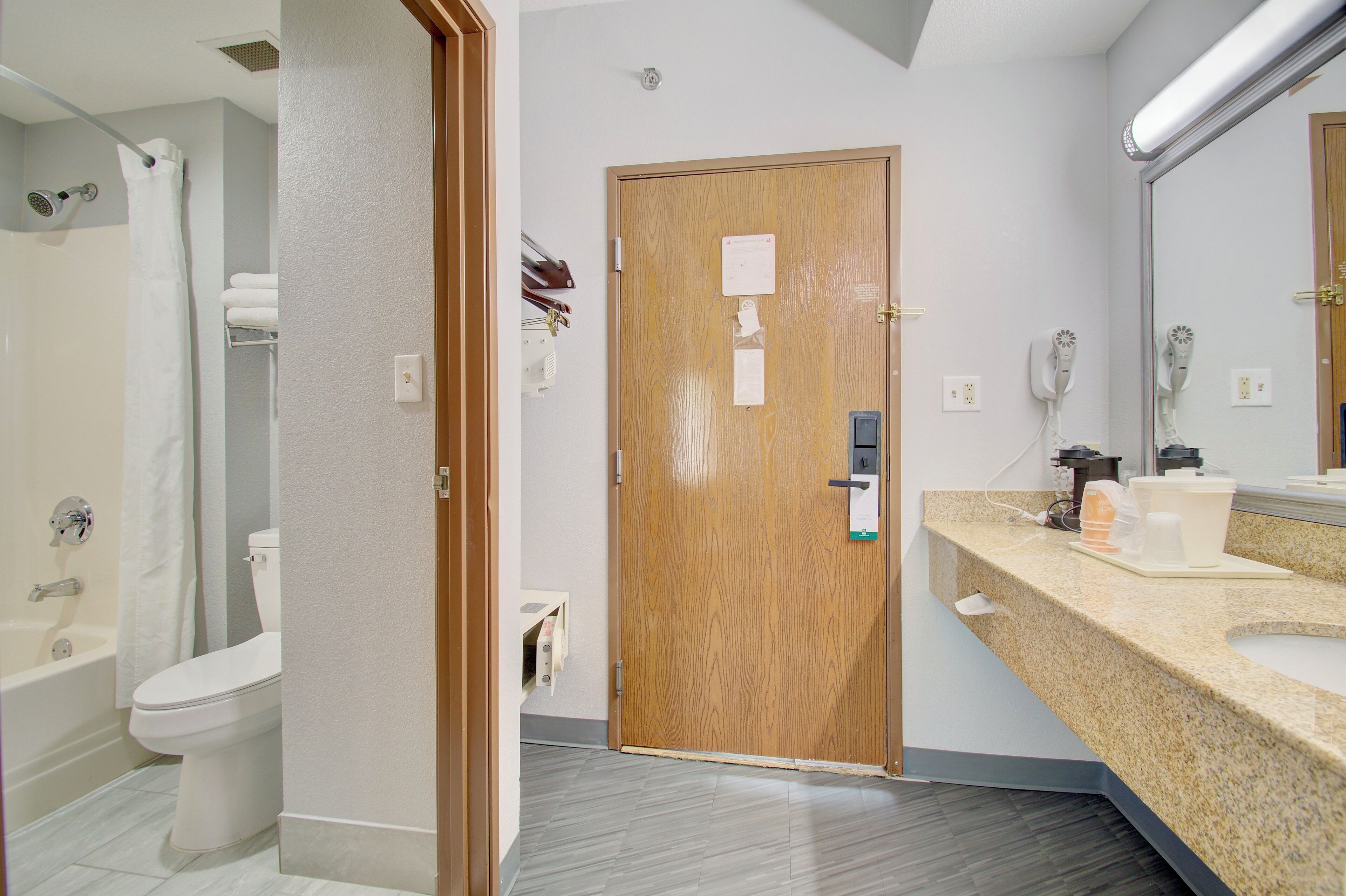 A modern bathroom with a shower, toilet, and sink.