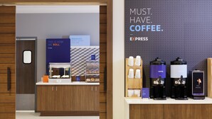 A coffee station with multiple coffee machines and a sign that reads 'MUST HAVE COFFEE.' - Candlewood Suites Dixon by IHG (Dixon)