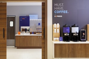 A coffee station with multiple coffee machines and a sign that reads 'MUST HAVE COFFEE.' - Candlewood Suites Dixon by IHG (Dixon)