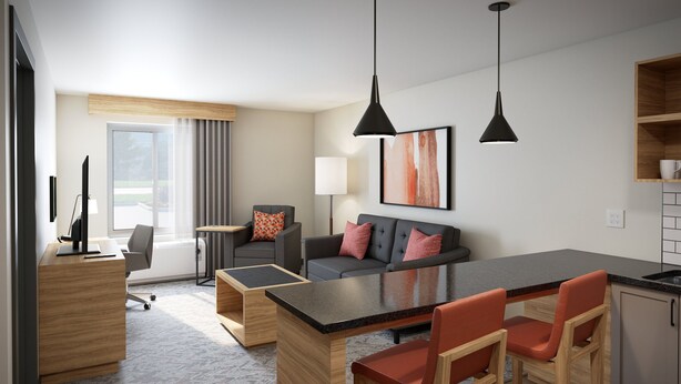 A modern hotel room with a dining area, a sofa set, a TV, and a large window. - Candlewood Suites Dixon by IHG (Dixon)