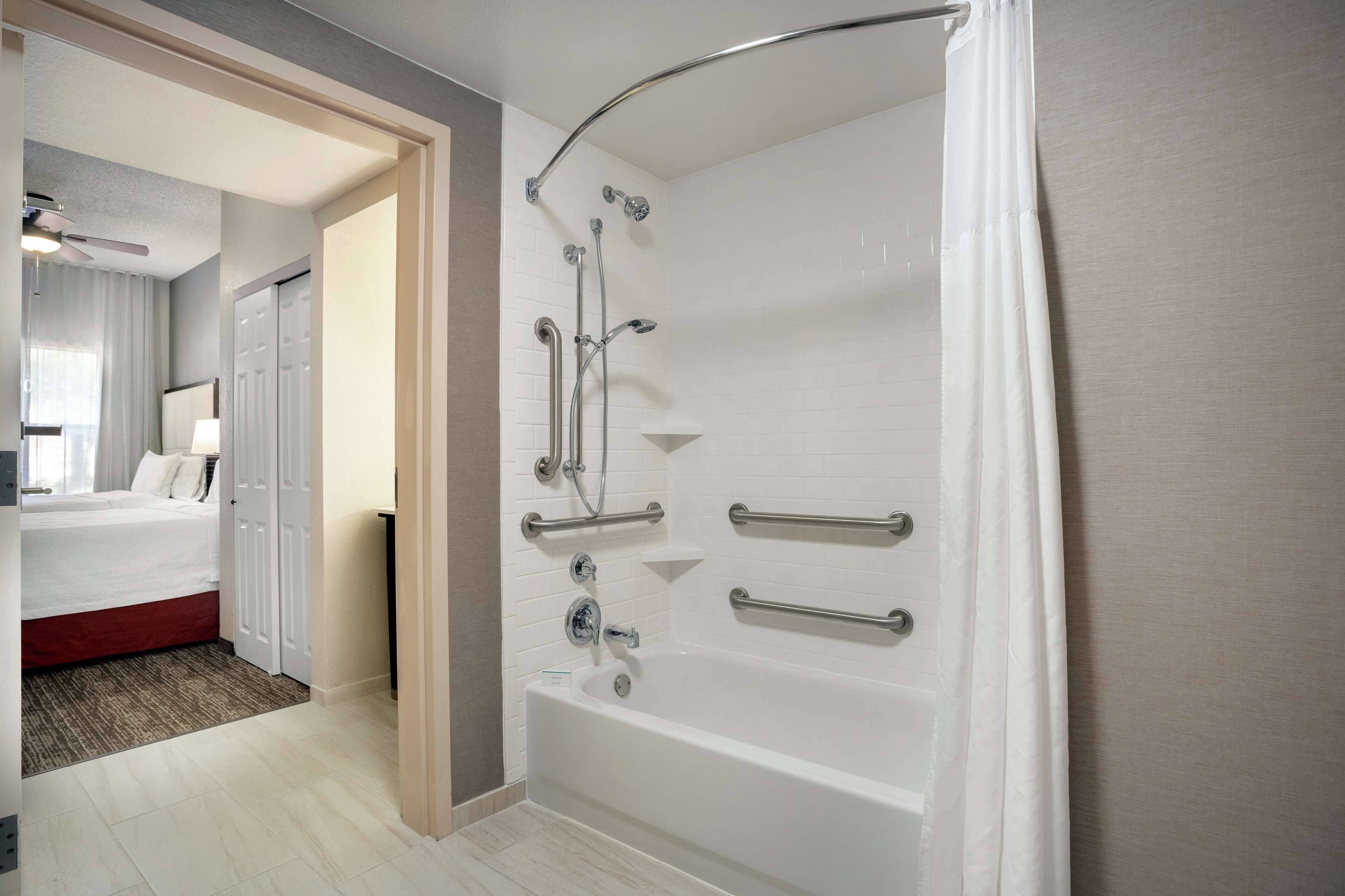 combined shower/bathtub, designer toiletries, hair dryer, towels