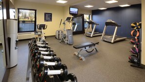 A gym with treadmills, elliptical machines, a bench, and a rack of dumbbells. - Hampton Inn High Point (High Point)