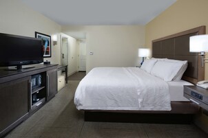 Premium bedding, desk, laptop workspace, blackout drapes