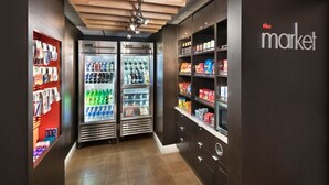 A store interior with refrigerated display cases, shelves stocked with snacks, and a wooden ceiling. - Courtyard by Marriott Burlington (Burlington)