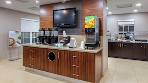 A modern kitchen area with a coffee station, a large flat-screen TV, and a refrigerator. - Residence Inn by Marriott Little Rock (Little Rock)