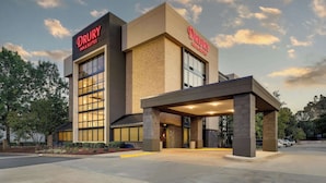 A Drury Inn & Suites building with a modern architectural design, large windows, and a covered entrance area.