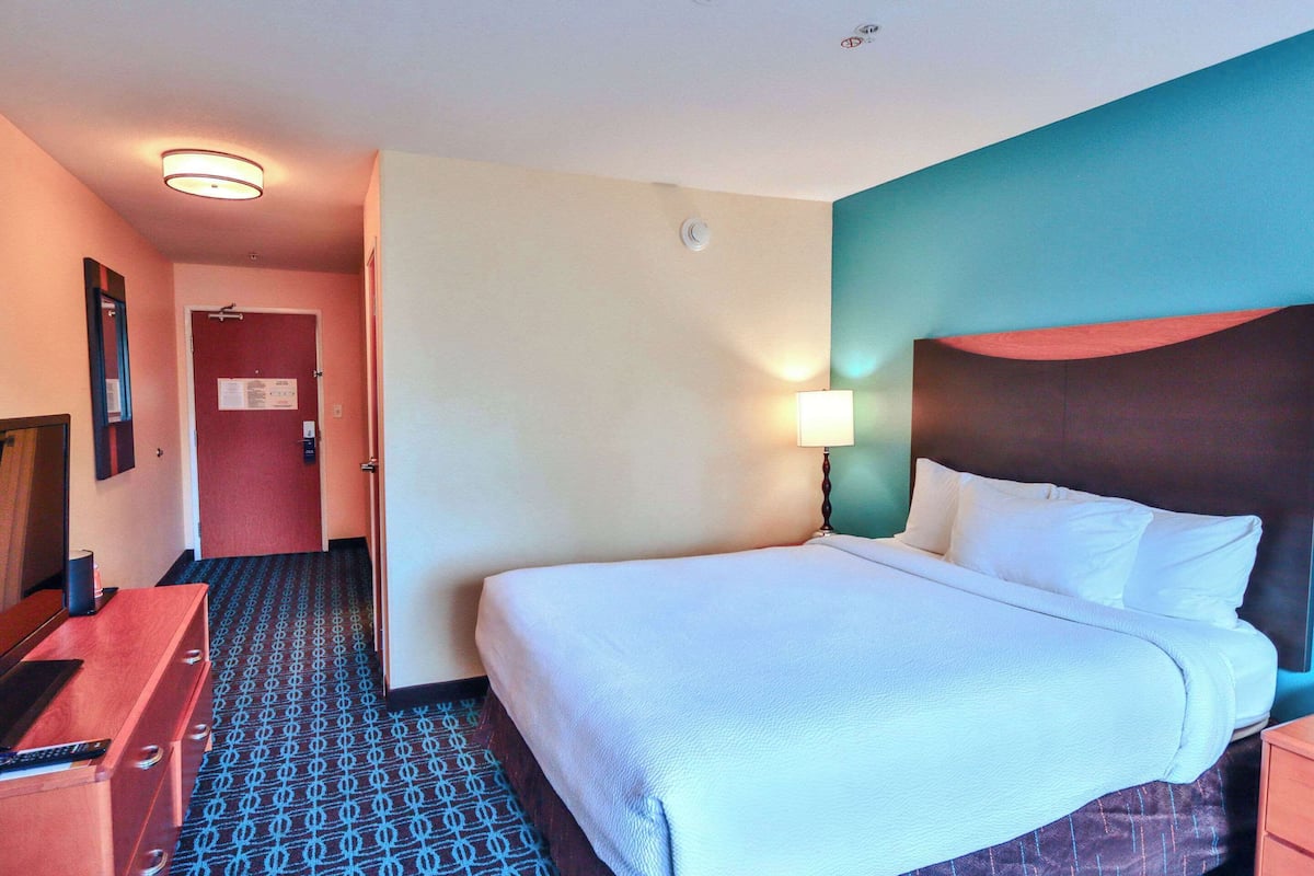 Hypo-allergenic bedding, desk, laptop workspace, blackout drapes