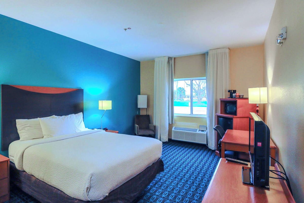 Hypo-allergenic bedding, desk, laptop workspace, blackout drapes