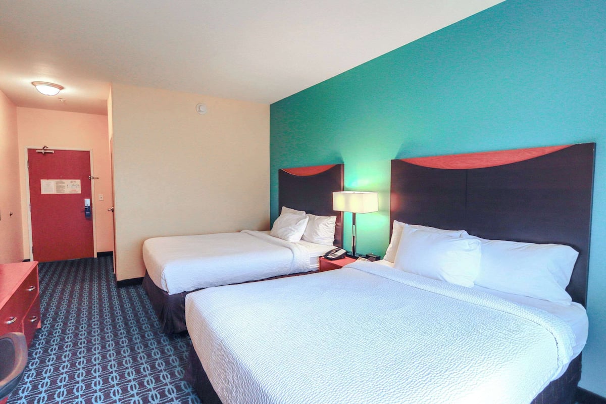 Hypo-allergenic bedding, desk, laptop workspace, blackout drapes