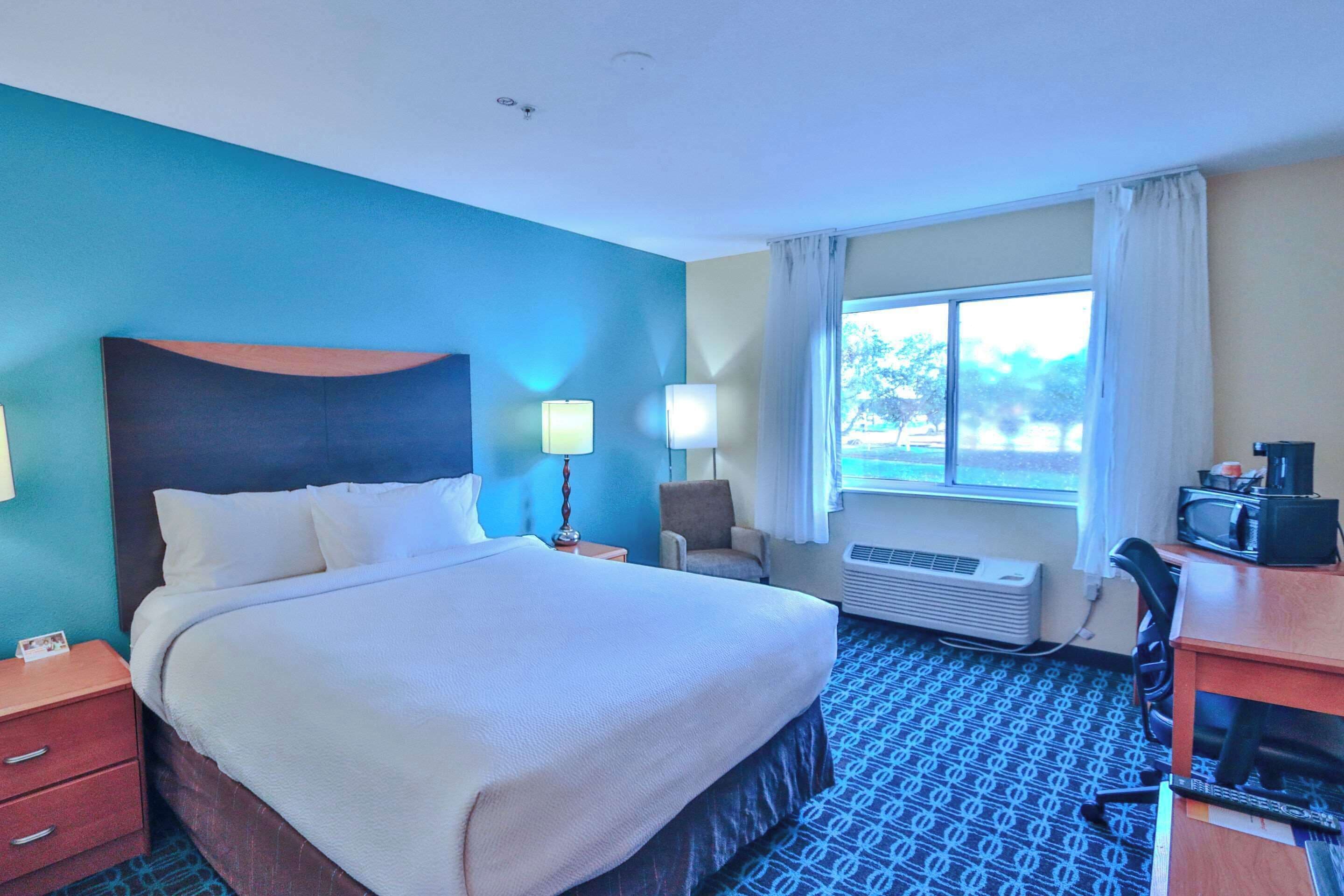 Hypo-allergenic bedding, desk, laptop workspace, blackout drapes