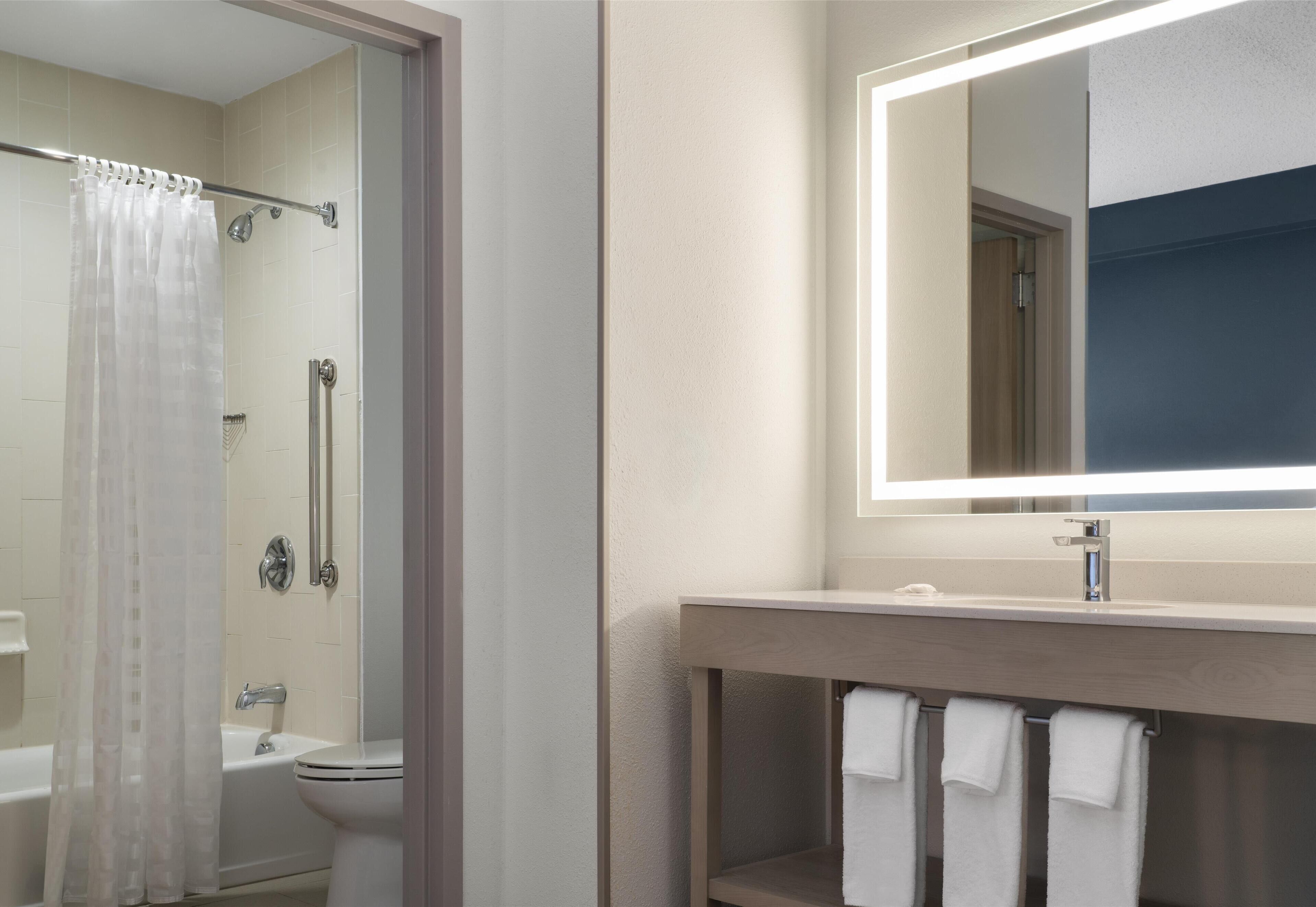 designer toiletries, hair dryer, towels, soap