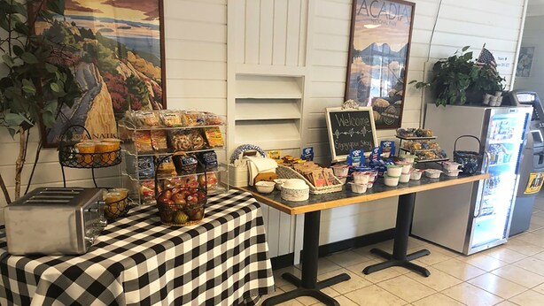 A breakfast buffet setup with various food items and a toaster.