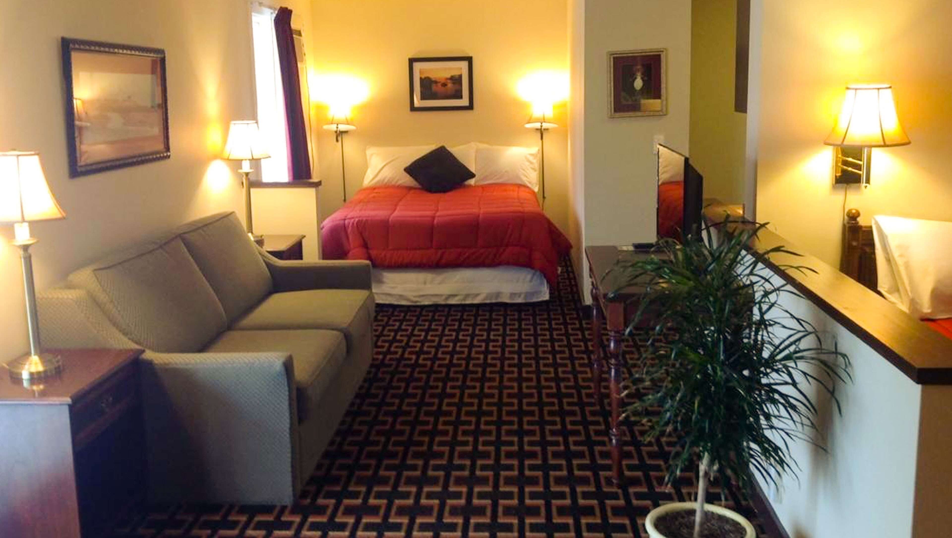 Room, Multiple Beds, Kitchenette (3 Queen Bed Family Suite Non Smoking) | Desk, laptop workspace, blackout curtains, iron/ironing board