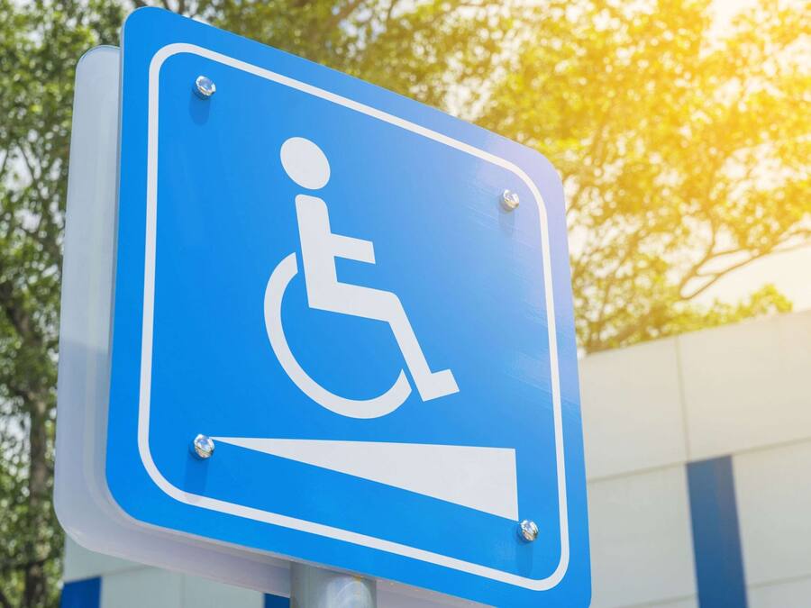 A blue handicap parking sign with a white wheelchair symbol.