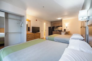 Laptop workspace, iron/ironing board, bed sheets, alarm clocks