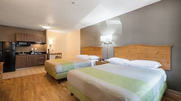 Laptop workspace, iron/ironing board, bed sheets, alarm clocks