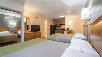 Laptop workspace, iron/ironing board, bed sheets, alarm clocks