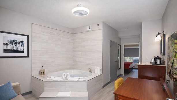 A modern bathroom with a freestanding bathtub, a shower, and a toilet. - Baymont Inn & Suites by Wyndham Morrow/Atlanta I-75 South (Morrow)