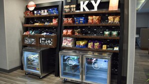 A snack display with various packaged foods and two beverage refrigerators. - Hampton Inn Frankfort (Frankfort)